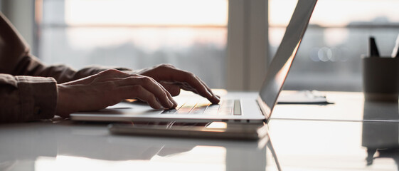 Man hands typing on computer keyboard closeup panoramic banner, businessman or student using laptop at home, online learning, internet marketing, working from home, office workplace, freelance concept