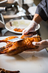 chinese chef cooking peking roasted duck at the kitchen of restaurant