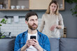 © Liubomir - Jealous wife quarrels over husband who uses phone, and keeps in touch with mistress, family quarrel and conflict