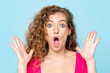 Shocked Caucasian woman screaming with open hands in isolated light blue color studio background