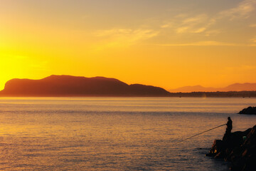 Wall Mural - Sunrise at Foro Italico Coast of Palermo on Sicily in Europa, Italy in late spring April on a warm sunny orange day