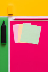 Wall Mural - top view of stationery near paper notes on colorful background.