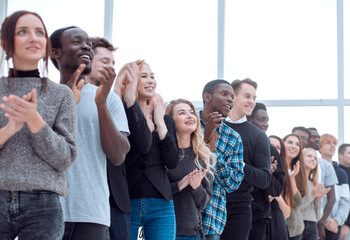 Wall Mural - group of diverse young people applaud standing in a row