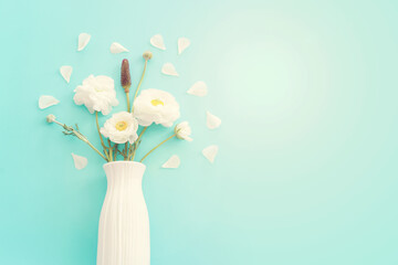 Wall Mural - Top view image of white flowers composition over blue pastel background