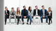 © ASDF - group of diverse business people applauding sitting in a row.