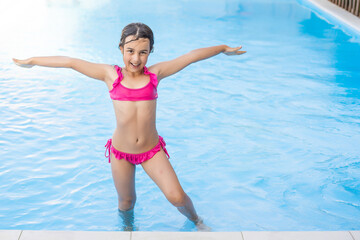 little girl having fun in the pool