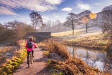 View Of Cyclist And Frosty Morning At The Cromford Canal, Derbyshire