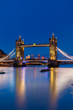 Tower Bridge At Sunset With Canary Wharf Skyline In Background, London