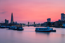 The Shard, Tower Bridge And City Of London Skyline With River Boats On The River Thames At Sunset, London