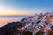 © robertharding - Sunset view of buildings overlooking sea, Oia, Santorini, Cyclades, Greek Islands