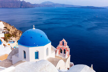 A White Church With Blue Dome Overlooking The Aegean Sea, Santorini, Cyclades, Greek Islands