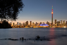 Toronto Skyline Featuring The CN Tower At Night Across Lake Ontario, From Toronto Islands Park, Toronto, Ontario
