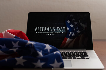 laptop with usa flag and inscription veterans day.