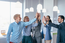 Business People Congratulating Stand In Office Doing A High Fives Hand Gesture.