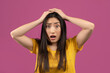 © Prostock-studio - Unbelievable news. Shocked asian woman touching her head, cannot believe amazing offer or sale, violet background