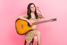 Photo Of Dreamy Charming Young Woman Wear Print Dress Arm Spectacles Playing Guitar Isolated Pink Color Background