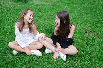 sisterhood. two sisters or friends spending time outdoors on sunny summer day. bff, sibling, girlfriend. millennial teen