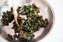 Red Swiss Chard Cooking In A Stainless Steel Pan