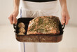 © Michael Marquand - Chef Holding a Pan with Prime Rib Roast with Garlic