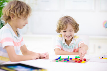 Wall Mural - Family playing board game. Kids play.