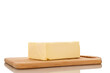 © Oleksandr - One piece of delicious butter on a wooden cutting board, close-up, isolated on a white background.