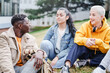 © EFStock - Happy college student friends talking having conversation in the University campus grass