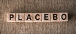 Placebo word written on blocks on wooden surface. Placebo effect, fake medical treatment