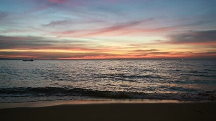 Poster - Tropical sea wave and colorful sky at the sunset