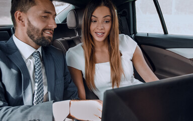 Wall Mural - Business man and woman working together in the car