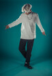 © qunica.com - Male beauty concept. Portrait of fashionable young man with stylish haircut wearing trendy glasses and sweater, posing over gray background. Perfect hair & skin. Hipster style. Copy-space. Studio shot