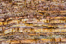 Closeup Of An Ancient Brown Cracked, Finely Layered Limestone Cliff