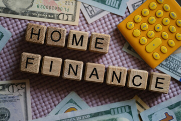 Wall Mural - Dollar bills and calculator lying near wooden cubes with words home finance closeup