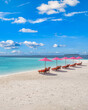 © icemanphotos - Amazing tranquil sea sand sky. Recreational summer travel tourism. Aerial landscape view with chairs and umbrellas on paradise island beach, seaside. Resort vacation, exotic nature. Beautiful tropics
