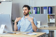 © Liubomir - Hot in the office, a businessman in a shirt working in a bright modern office, waving his arms trying to freshen up