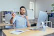 © Liubomir - Businessman works during the day in a modern office, man holds hot air conditioner in his hands, reduces air temperature