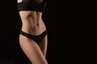 © Olga - sexy figure of a girl on a black background
