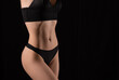 © Olga - Muscular body of a woman in lingerie on a black background