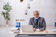 © Elnur - Old male employee drinking coffee during break