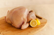 © Michael Marquand - Raw Turkey on a wooden cutting board with lemon