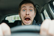 © glebcallfives - Close up portrait of shocked male driver with surprised face and open mouth.