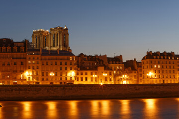 Poster - Embankment of the Seine near the Ile de la Cite at night, Notre Dame in the background, Paris.