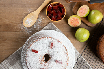 Brazilian corn cake made with a type of corn flour (Fuba) filled with guava paste. On a wooden party table. Typical sweets of the June festival. Cornmeal cake