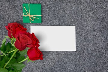 Sticker - Valentines day concept. White greeting card with red rose flowers bouquet and gift box on stone table