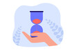 Hand holding hourglass with sand flowing down. Person counting time with sandglass flat vector illustration. Countdown, deadline, patience concept for banner, website design or landing web page