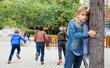 © JackF - Cute tween girl playing hide and seek with her friends on playground in autumn day