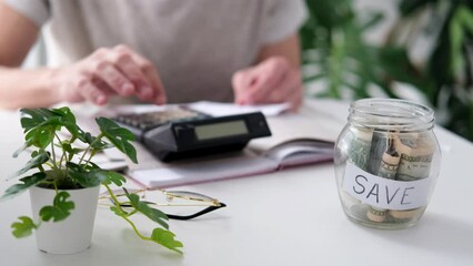 Wall Mural - a man counts a bill on a calculator on the table. payment of utility services. saving energy and mon