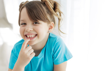 The kid lost a tooth. Baby without a tooth. Portrait of a little girl no tooth. High quality photo