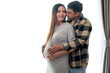 © tonefotografia - Young pregnant woman with husband embracing and expecting a baby at home
