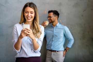 Wall Mural - Happy businesswoman using mobile phone while analyzing weekly schedule in corporate office