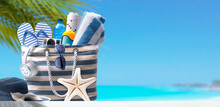 Beach Bag With Accessories And Tropical Beach